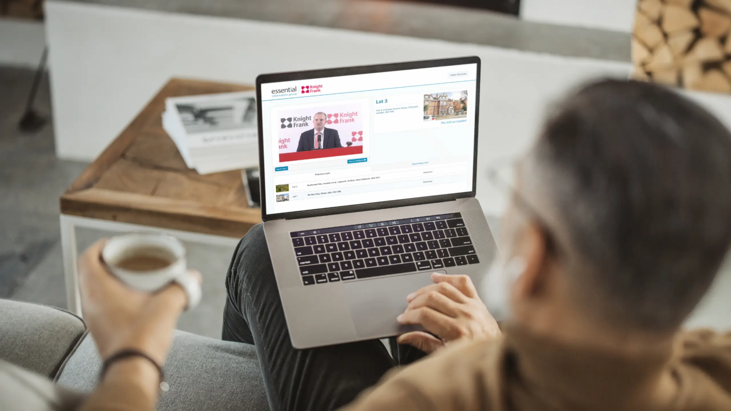 Man watching live Knight Frank auction on his laptop