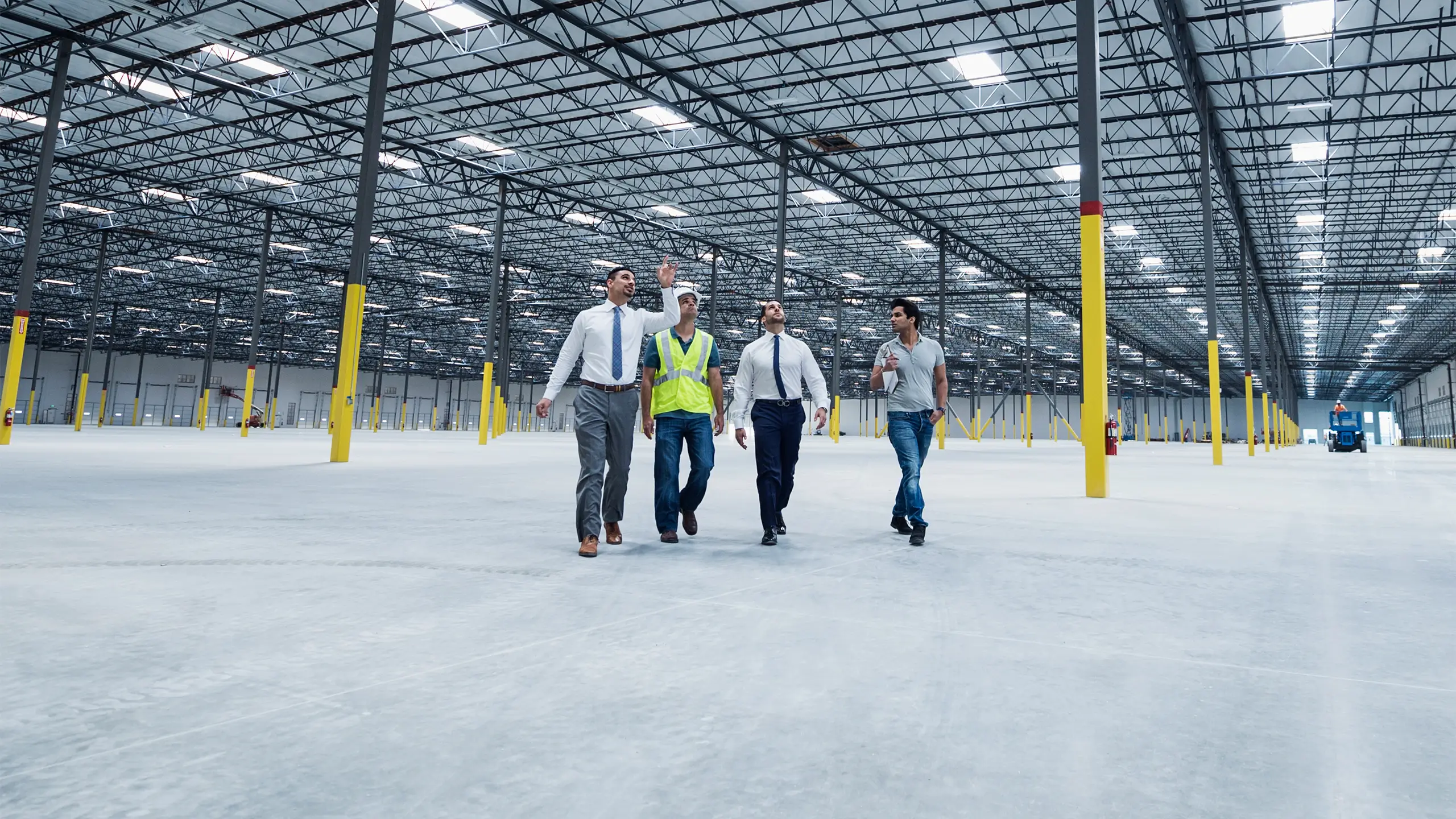 Businessmen walking and talking in empty warehouse
