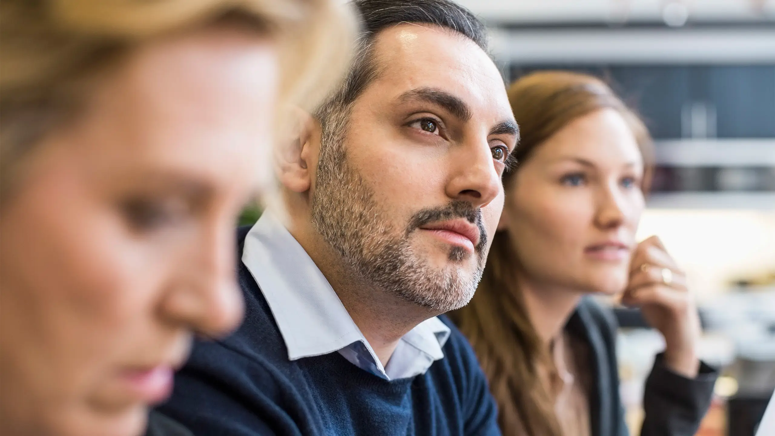 Concentrated businessman looking away in office meeting