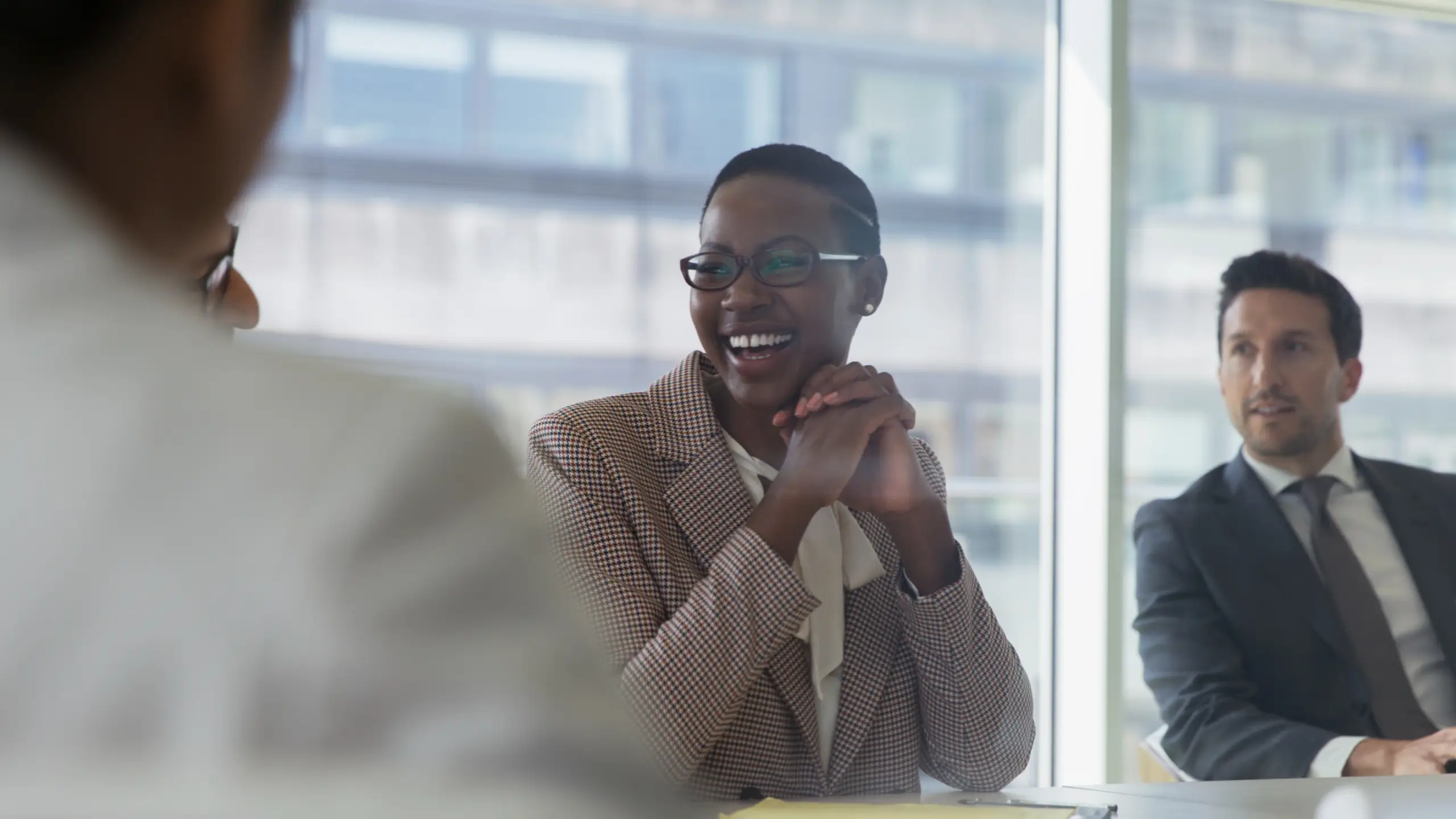 Businesswoman laughing with colleagues during a meeting