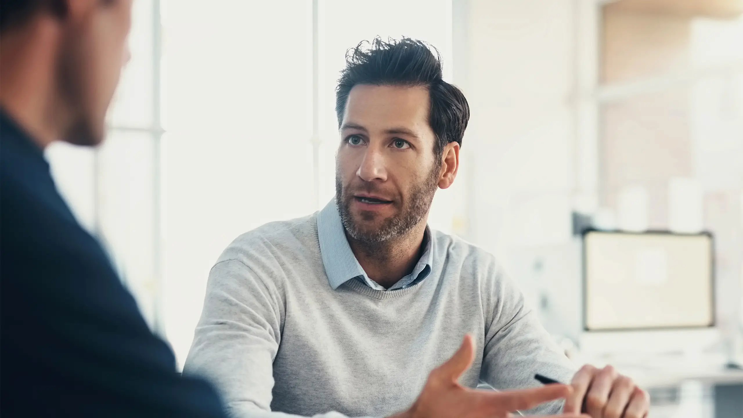 Planning, consulting or business man in meeting with notebook for strategy, analytics research or data analysis. Focus, teamwork or manager for creative idea, company growth or schedule agenda review