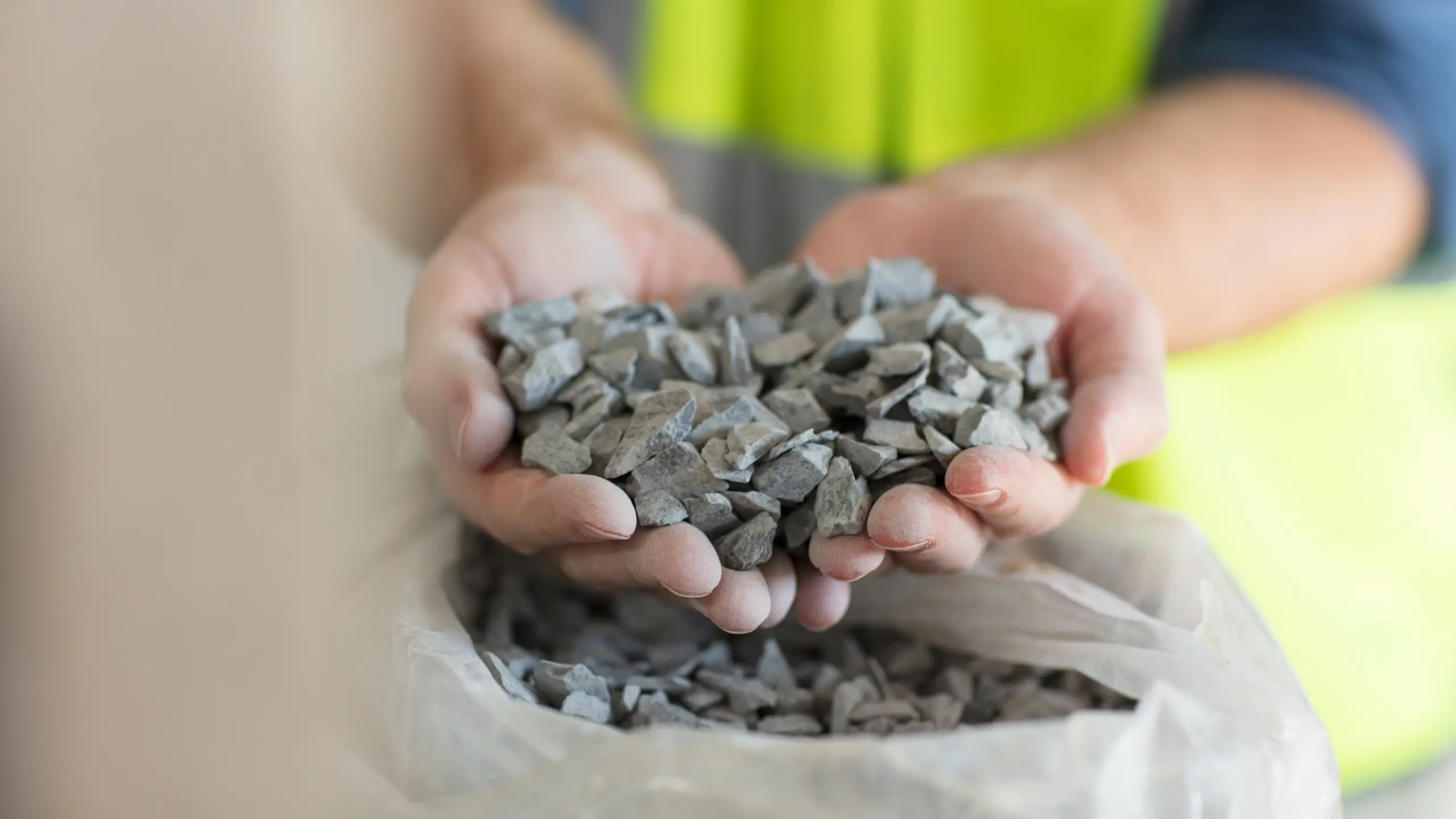 Close up of a worker holding gravel